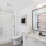 bathroom with sink mirror and large shower